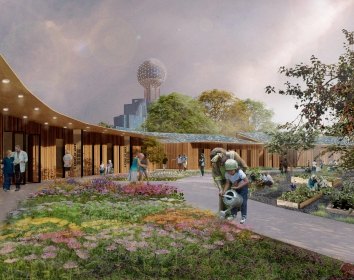 A woman and child watering plants in a concept center beneath Reunion Tower